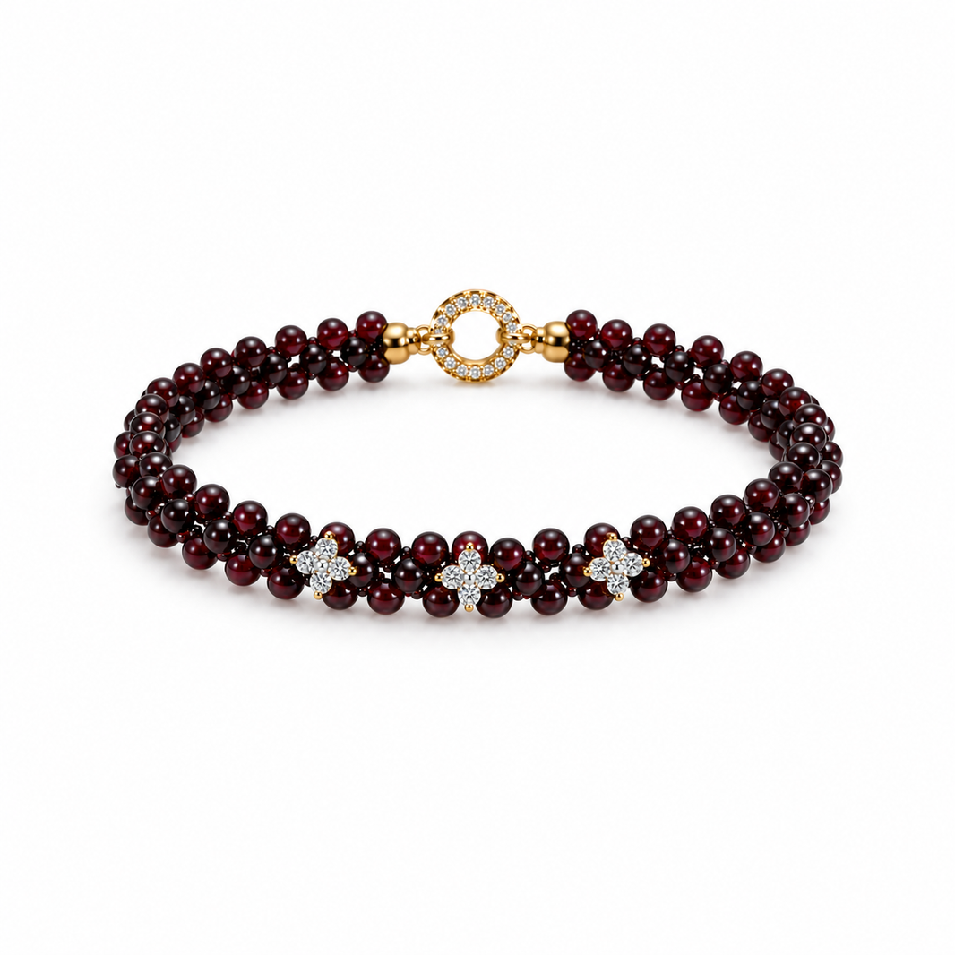 Woven burgundy garnet bracelet with three floral accents on white background