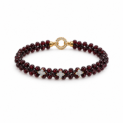 Woven burgundy garnet bracelet with three floral accents on white background