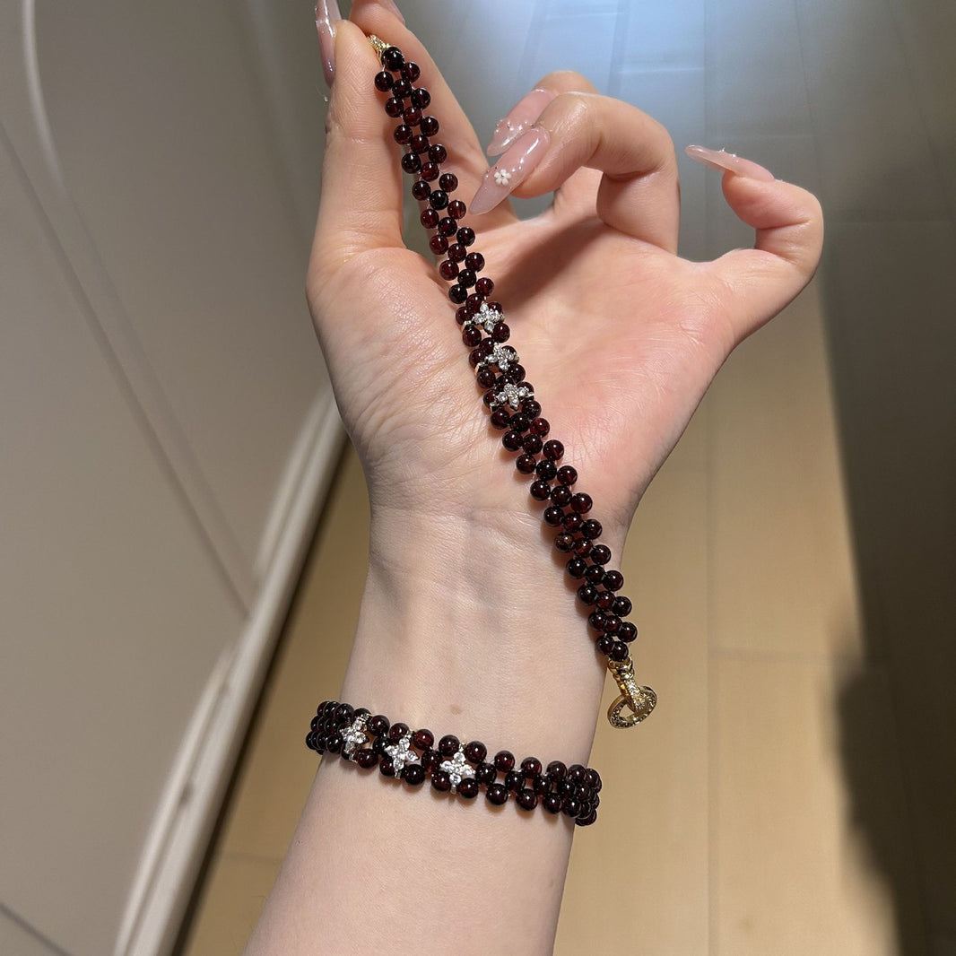 Garnet bracelet shown on the wrist and held for scale