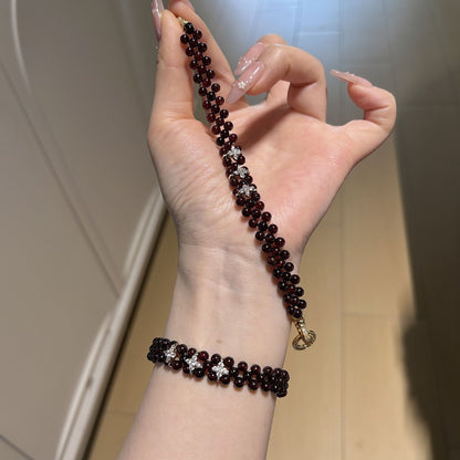 Garnet bracelet shown on the wrist and held for scale