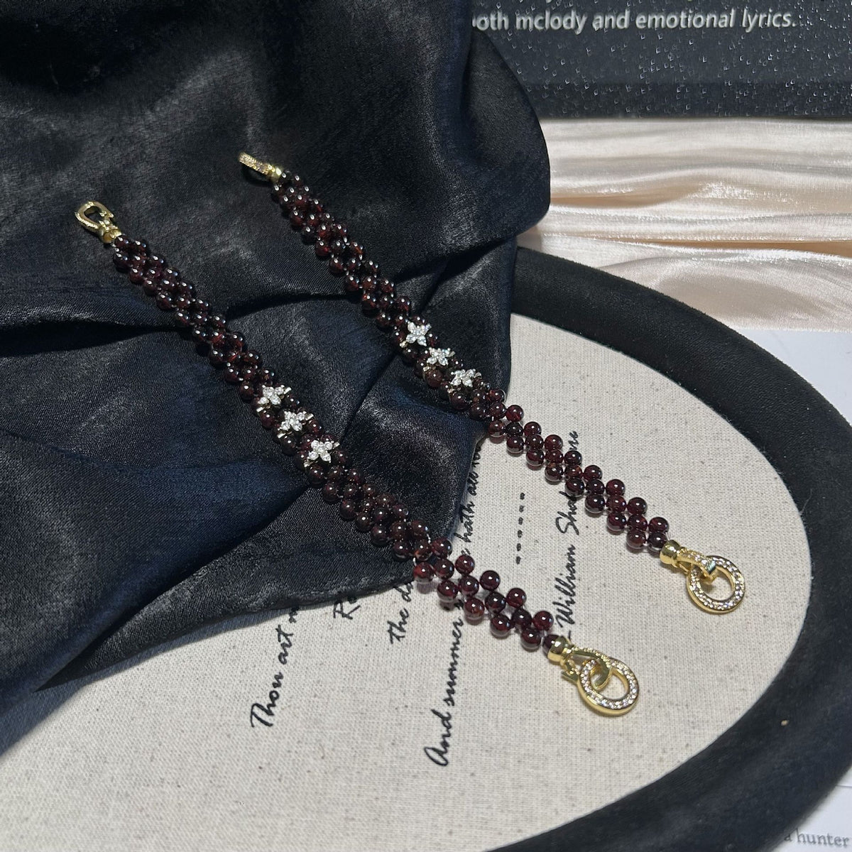Two examples of the same garnet bracelet design on fabric