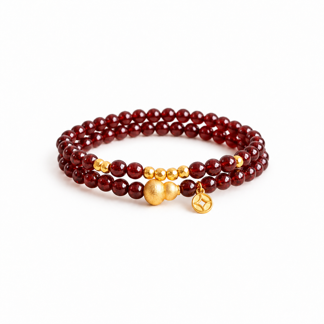 Garnet double-wrap bracelet with gold-colored gourd and coin charm on white