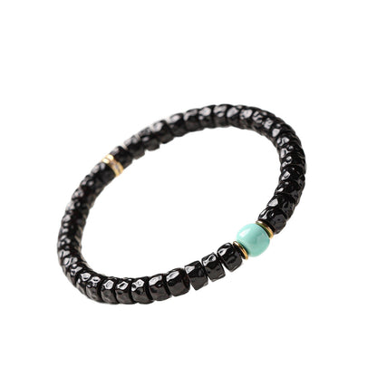 Complete coconut-pedicel bracelet design with pale blue center bead