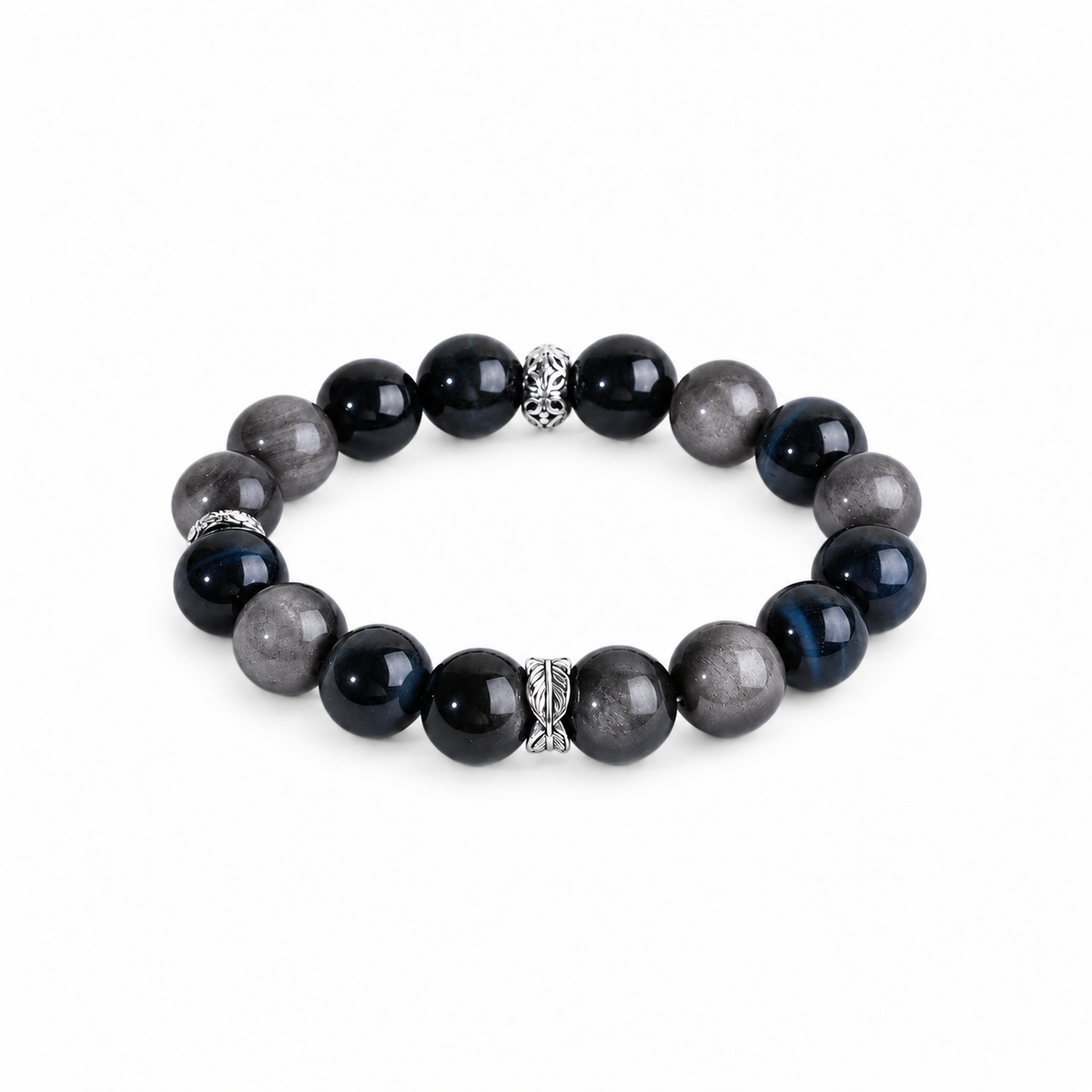Blue tiger eye and silver-sheen obsidian bracelet with three patterned silver-tone spacers on white