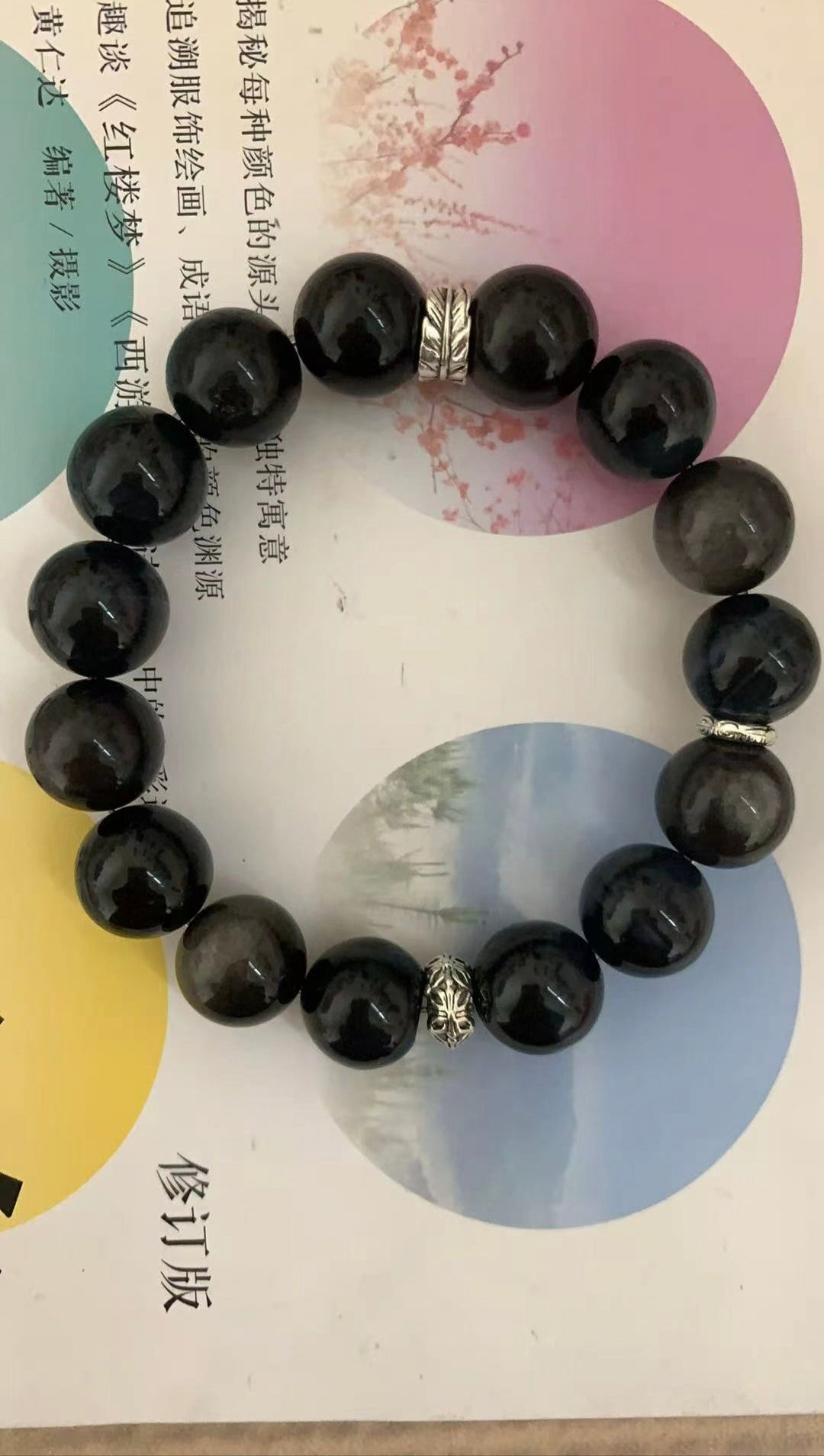 Original close-up of the bracelet resting on a book