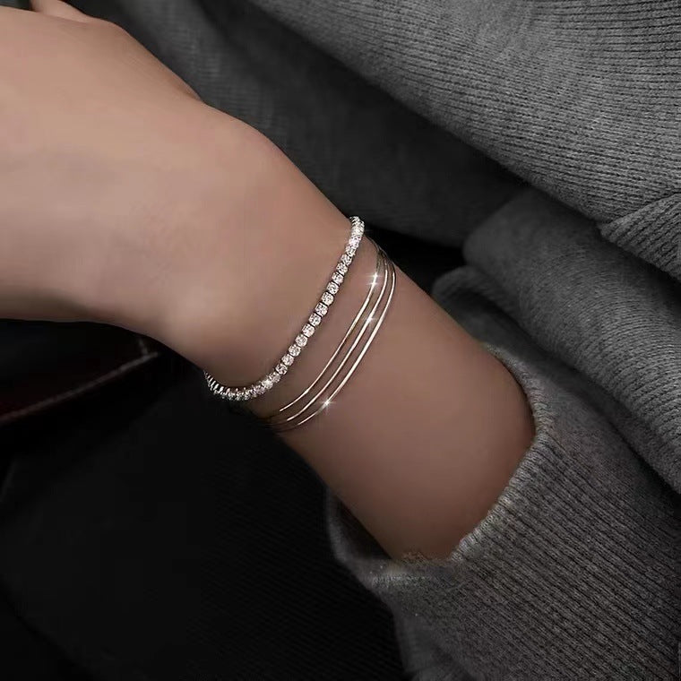Layered styling showing triple-strand snake chain bracelet