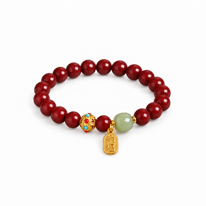 Deep red cinnabar bracelet with pale green accent and good fortune charm on white