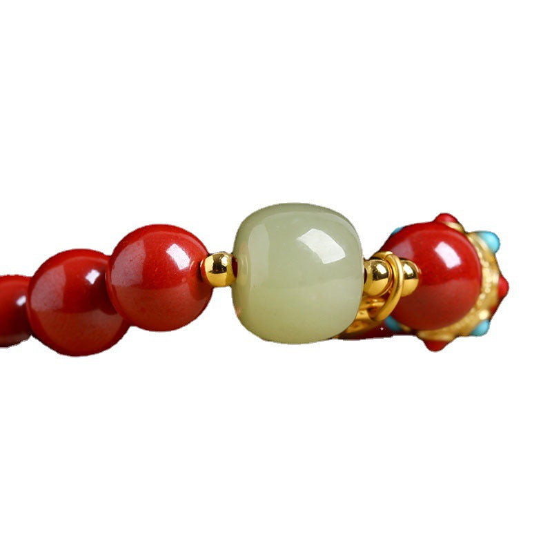 Pale green accent bead and red cinnabar bead detail