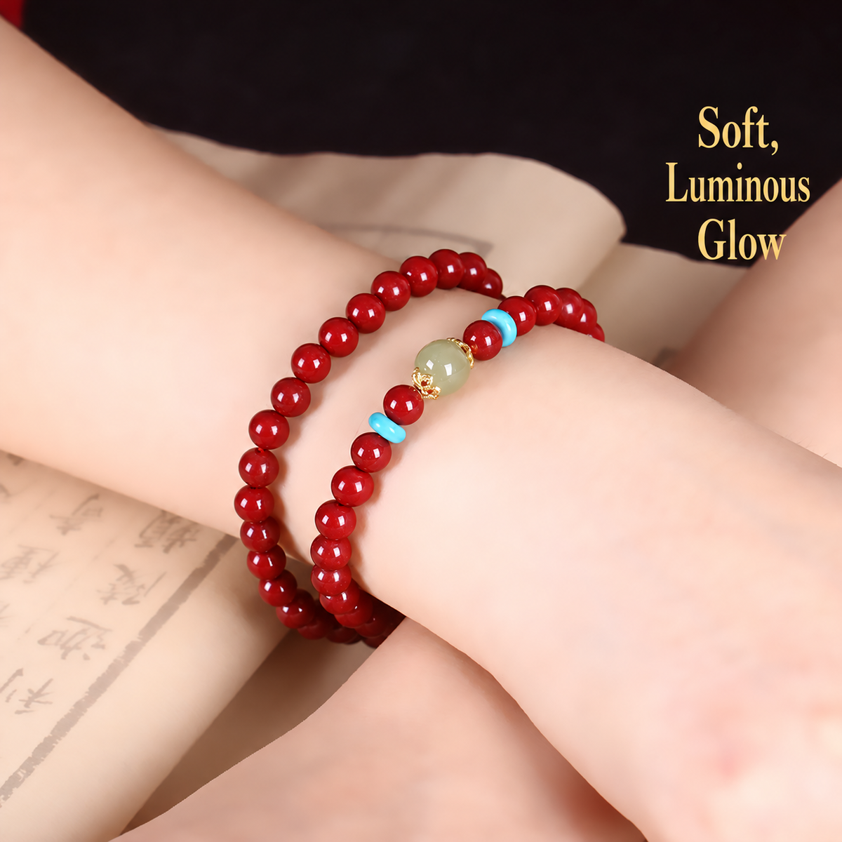 Cinnabar and jade double-wrap bracelet worn on wrist