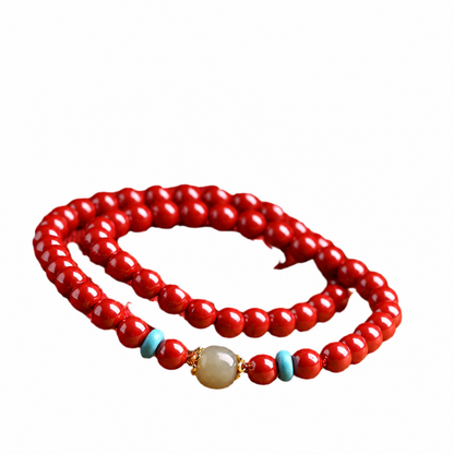 Bright red cinnabar and Hetian jade double-wrap bracelet on white