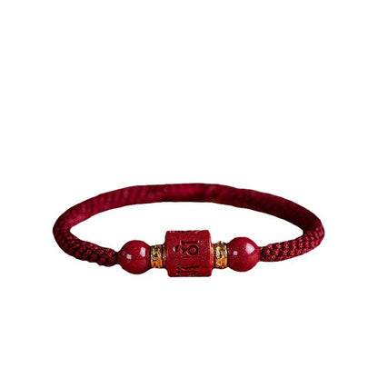Burgundy braided cord cinnabar bracelet with gold-colored spacers