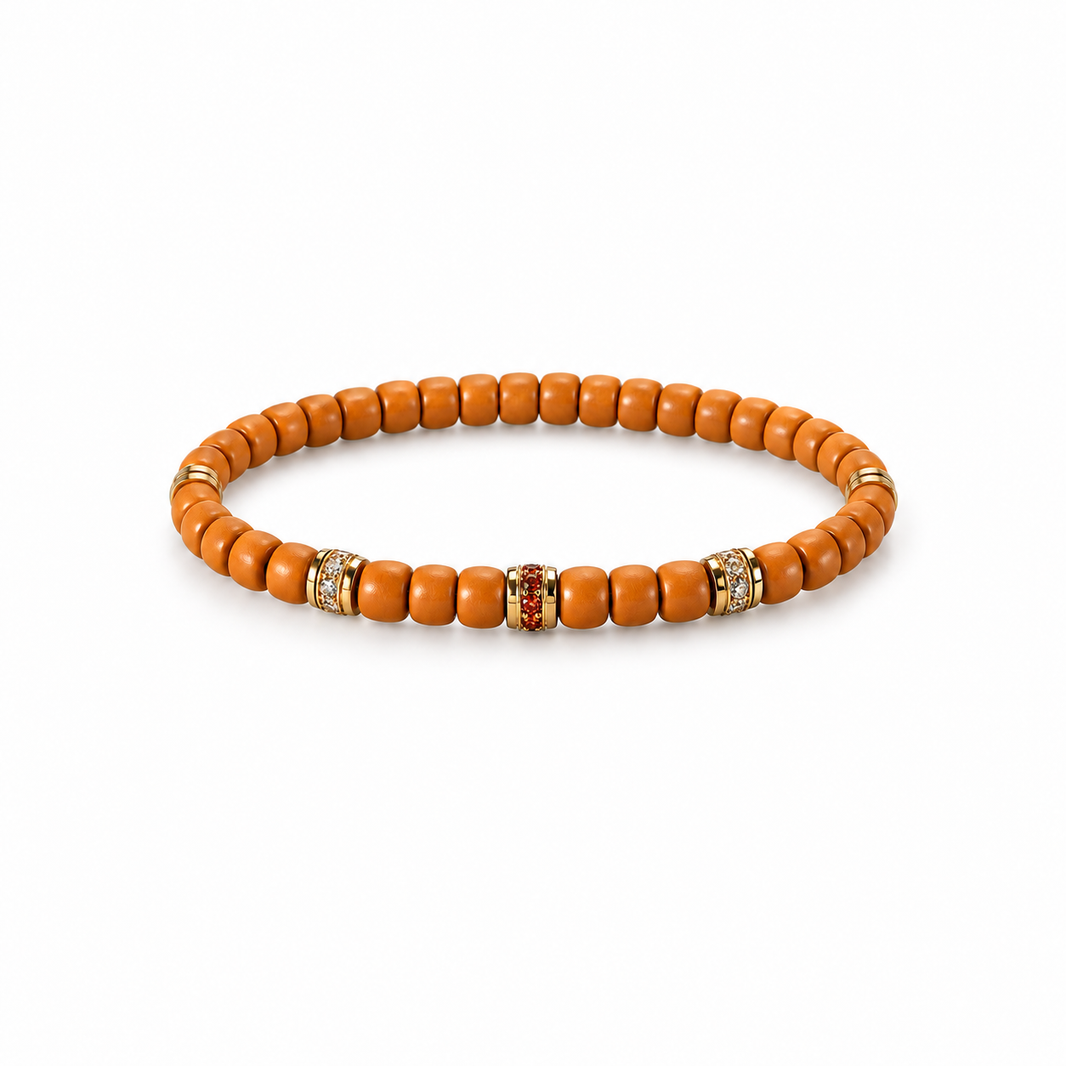 Olive pit bead bracelet with gold-tone colorful decorative spacers on white