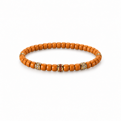Olive pit bead bracelet with gold-tone colorful decorative spacers on white