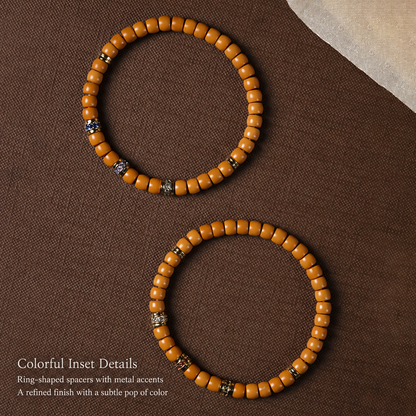 Two olive pit bracelets showing colorful decorative spacer details