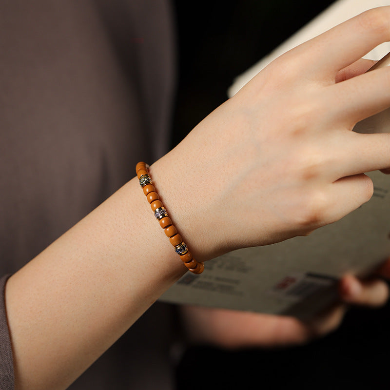 Olive pit bead bracelet worn on wrist
