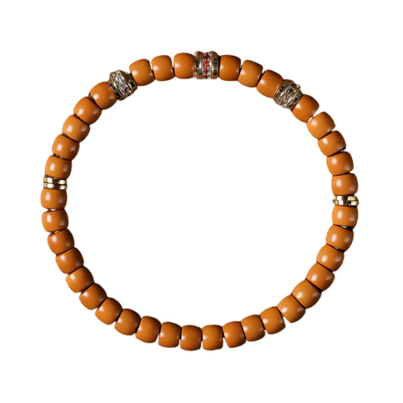 Olive pit bead bracelet with decorative spacers on white
