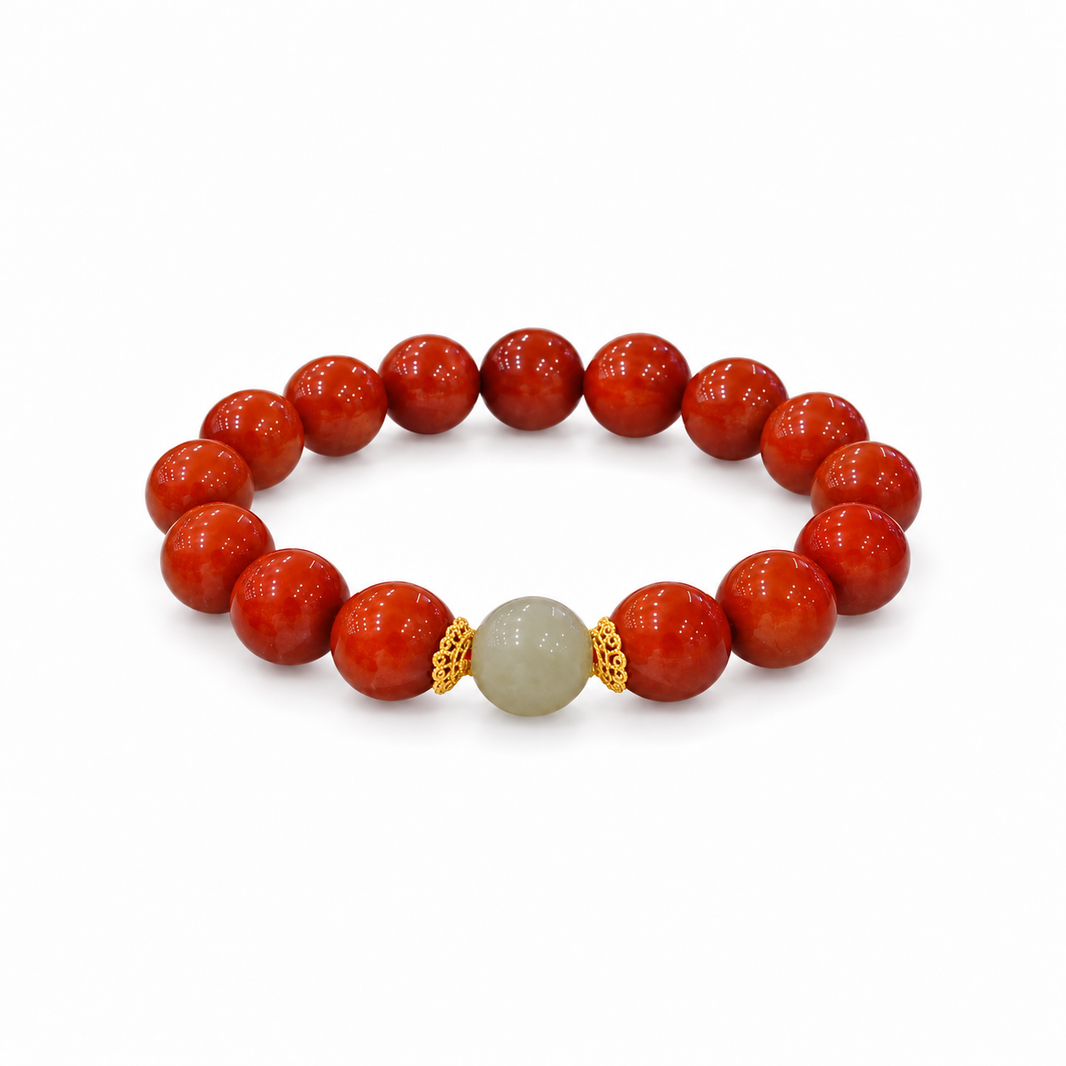 Nanhong red agate bracelet with a pale Hetian jade center bead and gold-tone caps on white