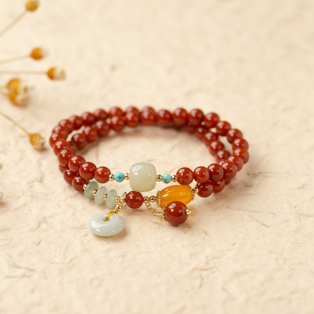 Red agate double-wrap bracelet with colorful decorative accents