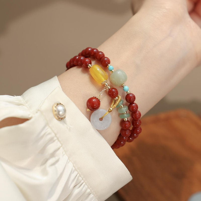Red agate peace disc bracelet worn on the wrist