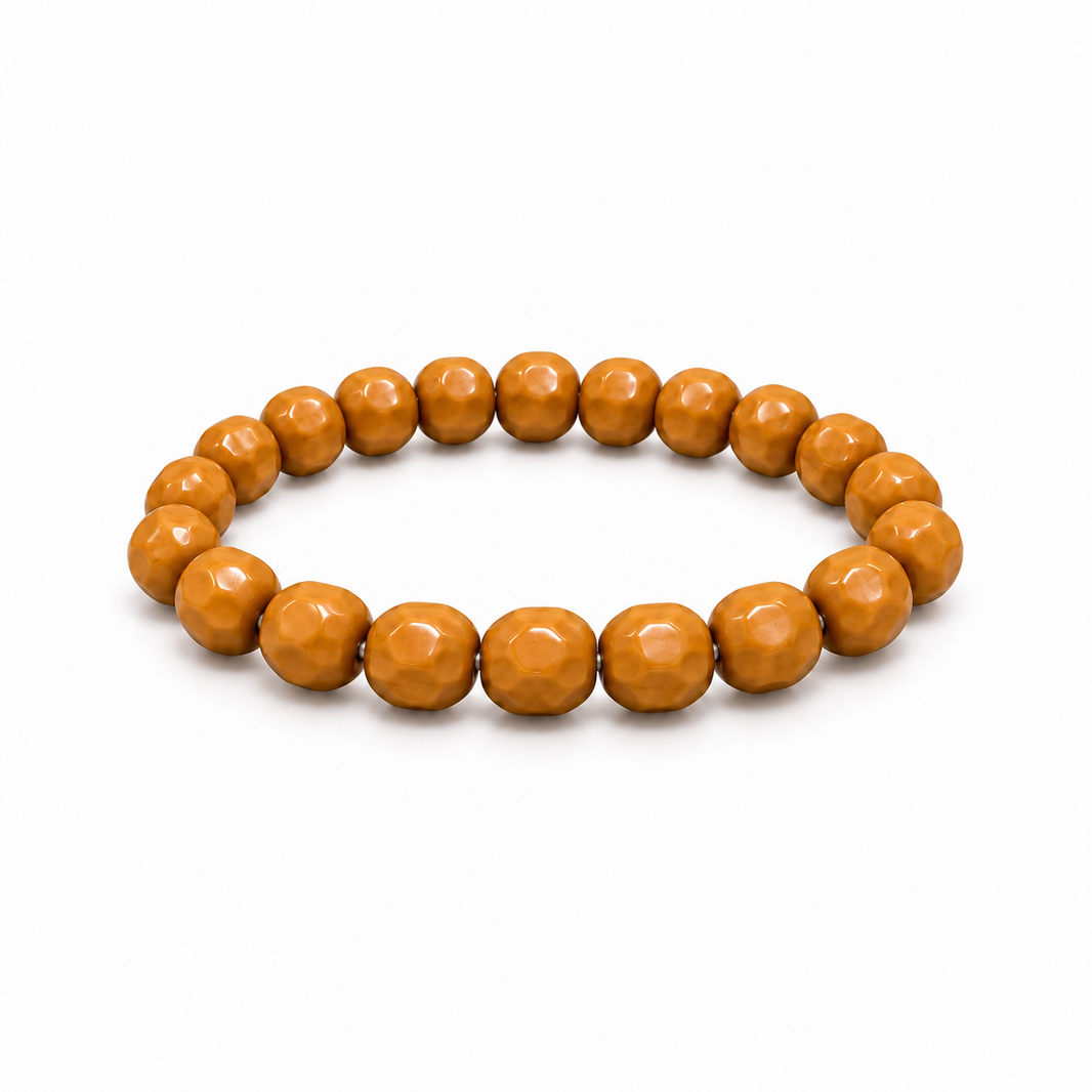 Cheese-cut walnut bead bracelet on a white background