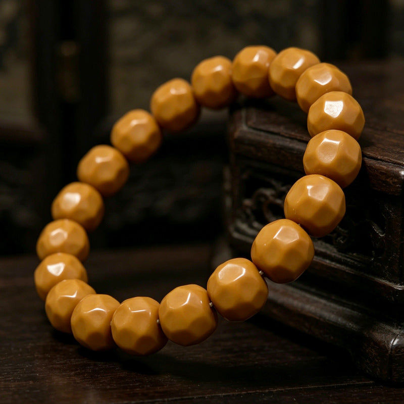 Carved walnut bead bracelet angled detail