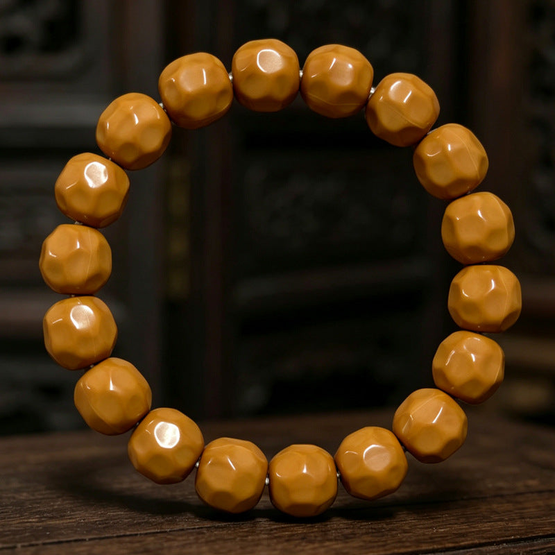 Polished walnut bracelet on a wooden surface