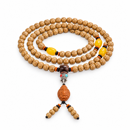 Golden Star and Moon Bodhi wrap strand with yellow accents and a carved pendant on white