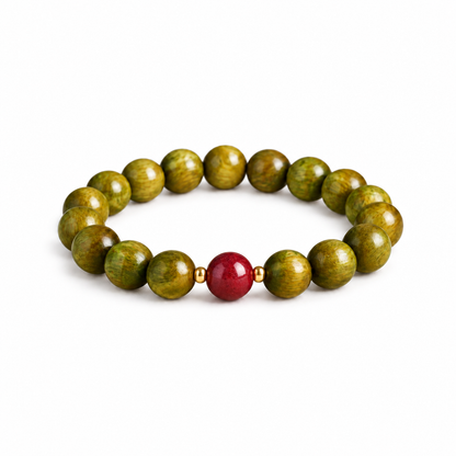 Green sandalwood bracelet with deep red cinnabar accent on white background