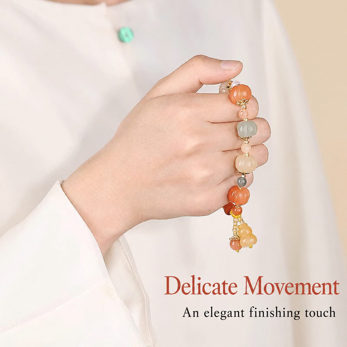 Carved pumpkin bracelet held in hand, refined detail