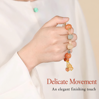 Carved pumpkin bracelet held in hand, refined detail