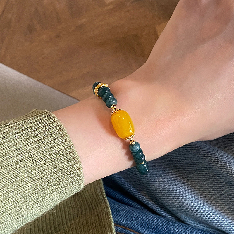 Yellow agate and teal chalcedony bracelet worn on wrist