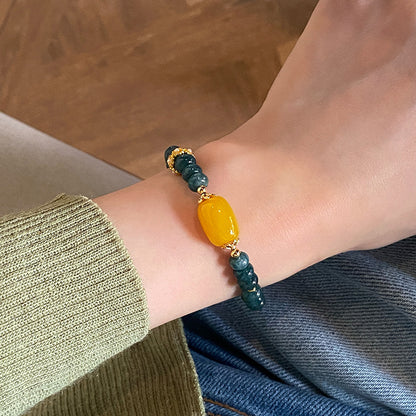 Yellow agate and teal chalcedony bracelet worn on wrist
