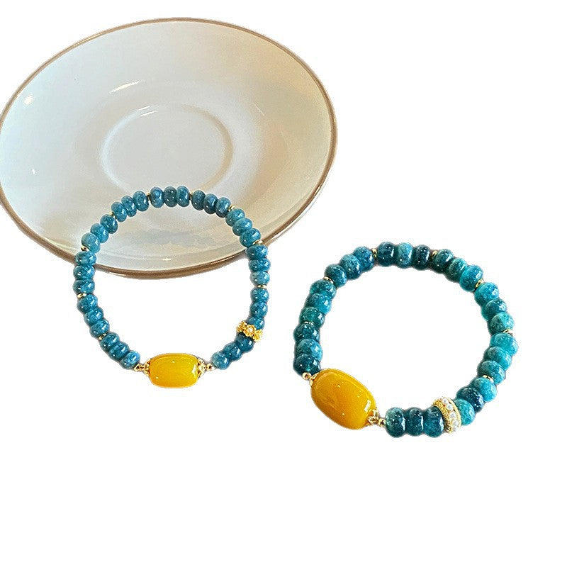 Comparison of teal rondelle bracelet designs with yellow agate accents