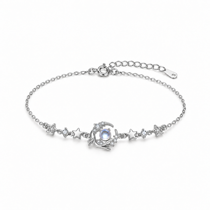 Sterling silver whale and star bracelet with blue glass center on white background