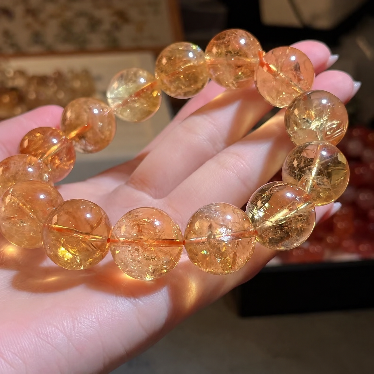 Golden yellow quartz bracelet showing natural internal textures held in a hand