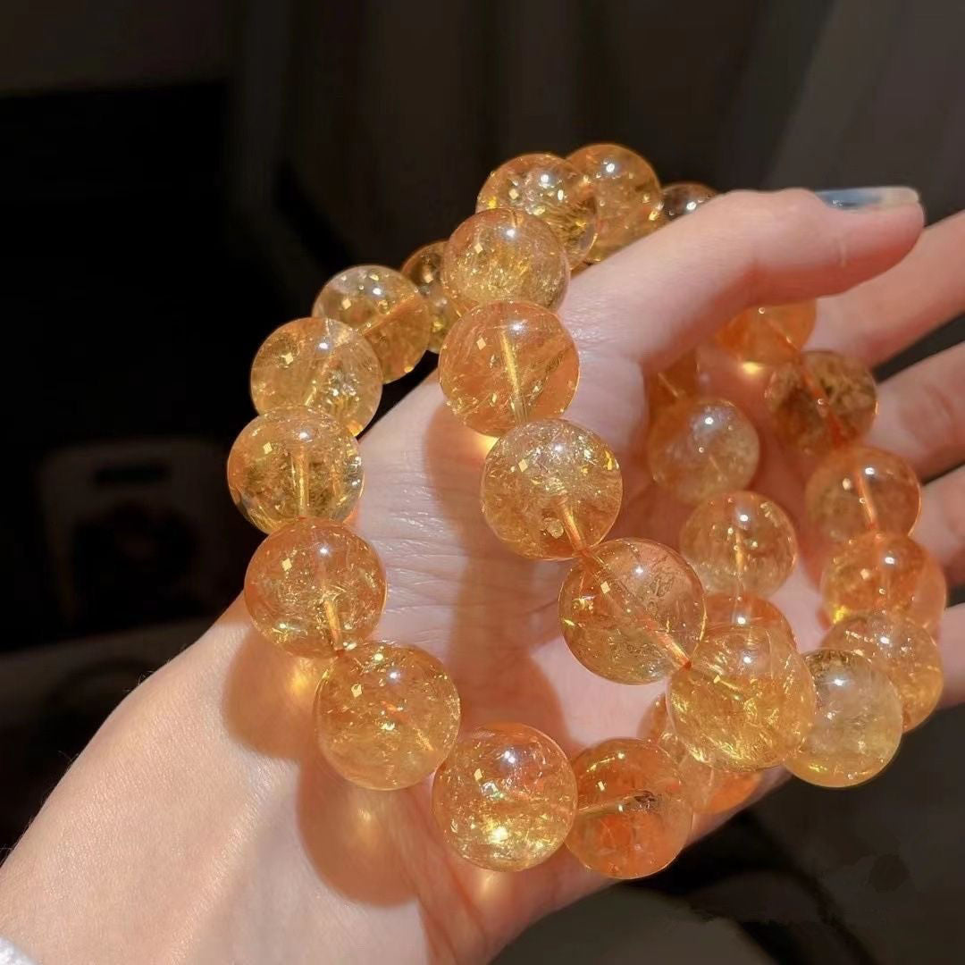 Original yellow quartz bracelets displayed together in a hand