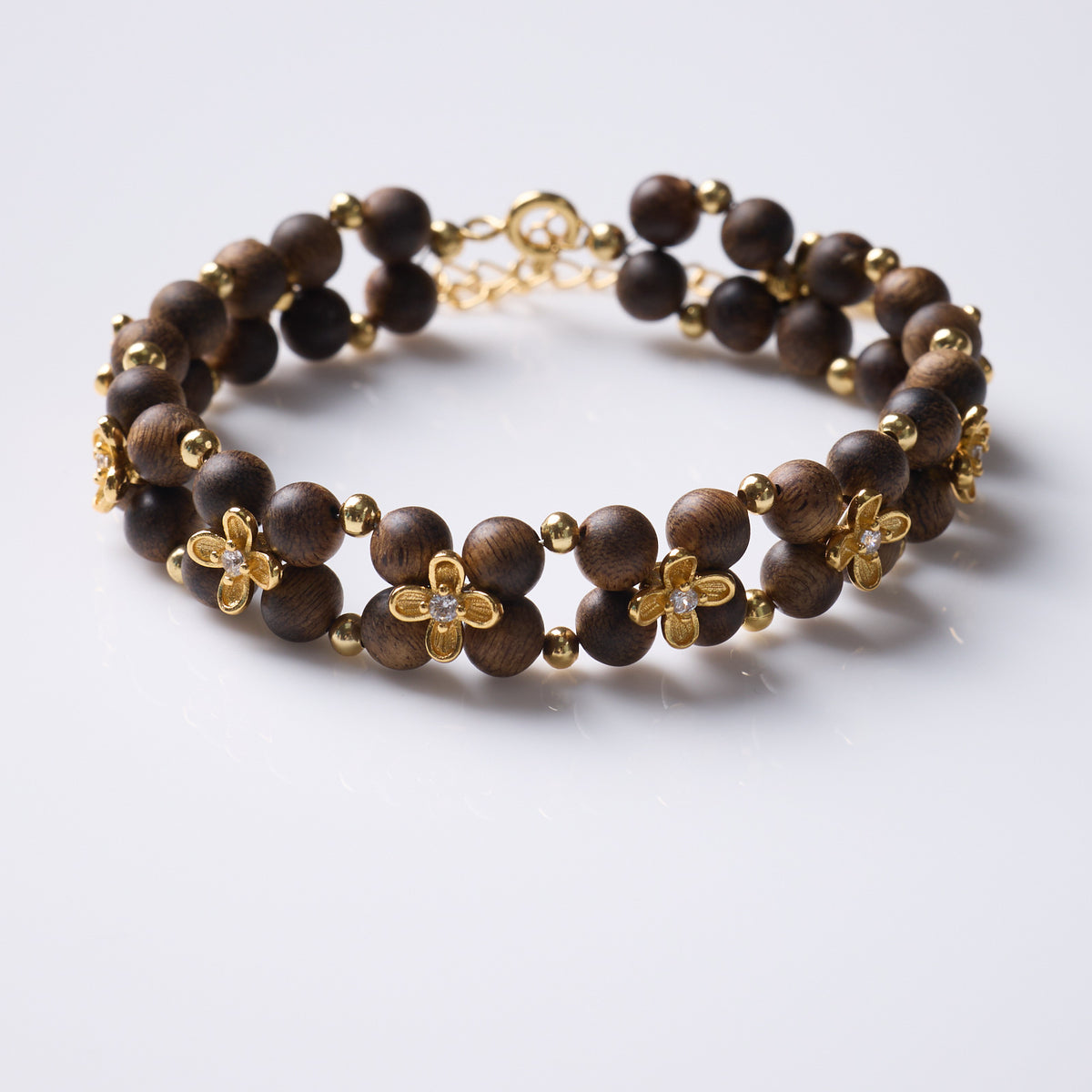 Agarwood double-row bracelet with gold-tone flowers