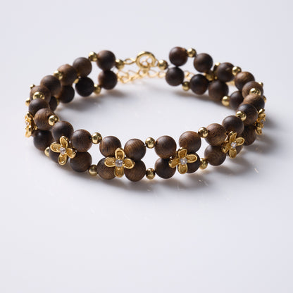 Agarwood double-row bracelet with gold-tone flowers