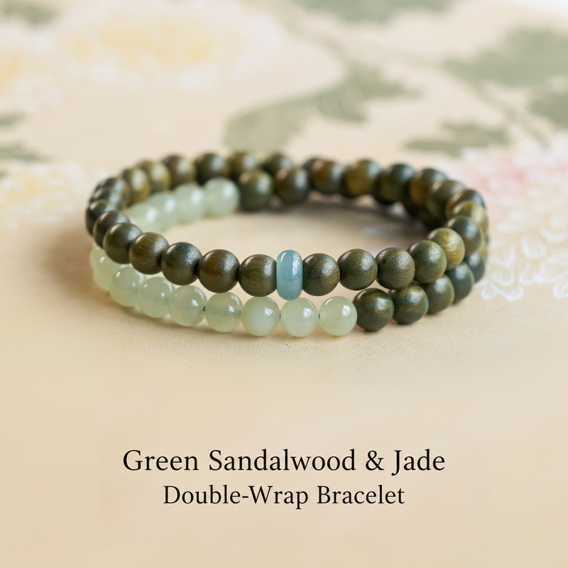 Green sandalwood and jade bracelet on floral cloth