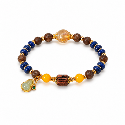 Lapis lazuli and agarwood bracelet with amber beads and a gourd charm on white