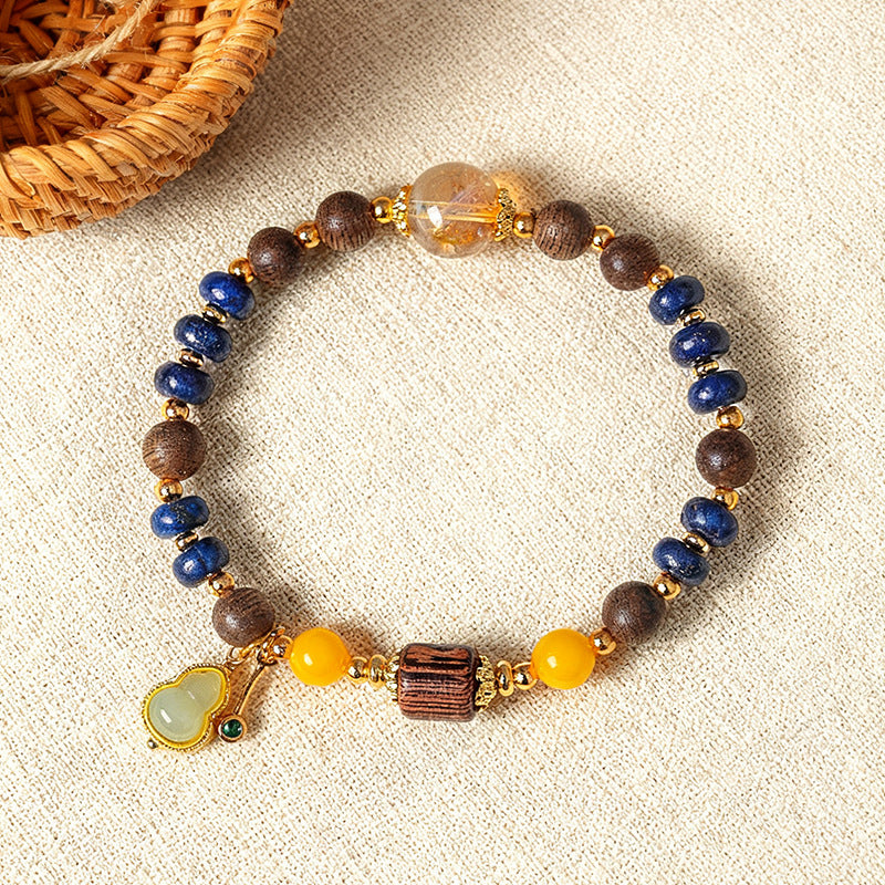 Lapis lazuli and agarwood bracelet with amber beads on linen