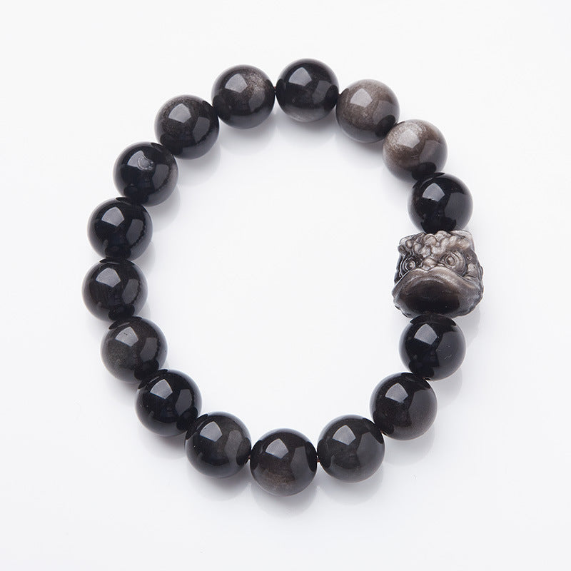 Silver-sheen obsidian bracelet showing polished beads and carved lion-dance head