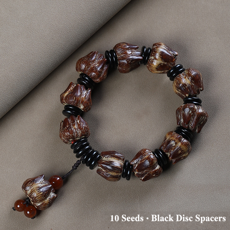 Ten-seed bodhi bracelet with black disc spacers and decorative seed tail