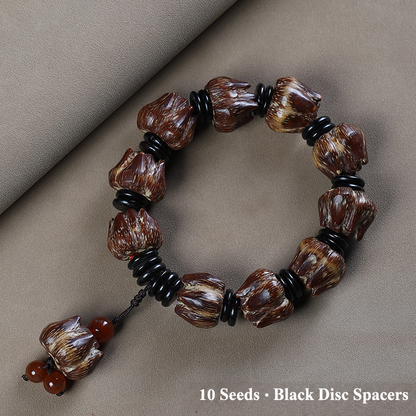 Ten-seed bodhi bracelet with black disc spacers and decorative seed tail