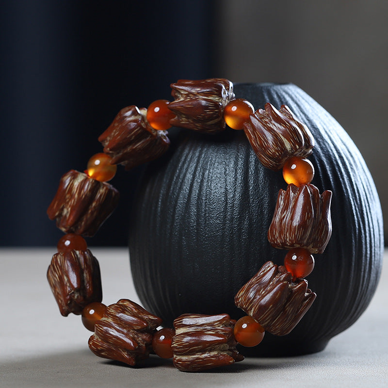 Nine-seed bodhi bracelet displayed on dark stand