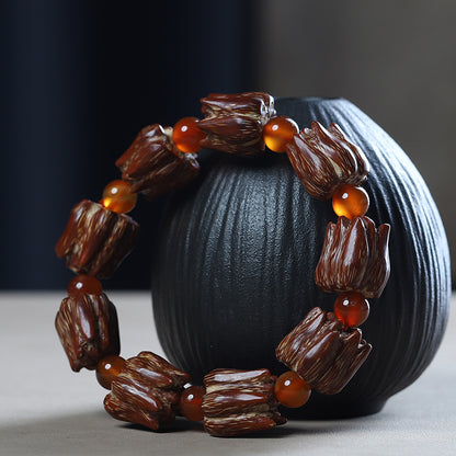 Nine-seed bodhi bracelet displayed on dark stand