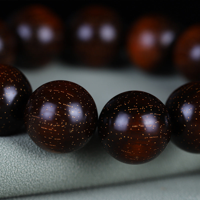 Close-up of red sandalwood grain and fine golden speckles