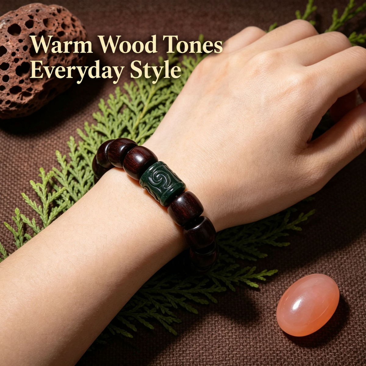 Carved green-accent red sandalwood bracelet worn on wrist