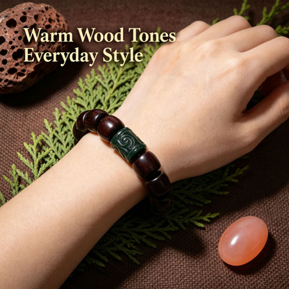Carved green-accent red sandalwood bracelet worn on wrist