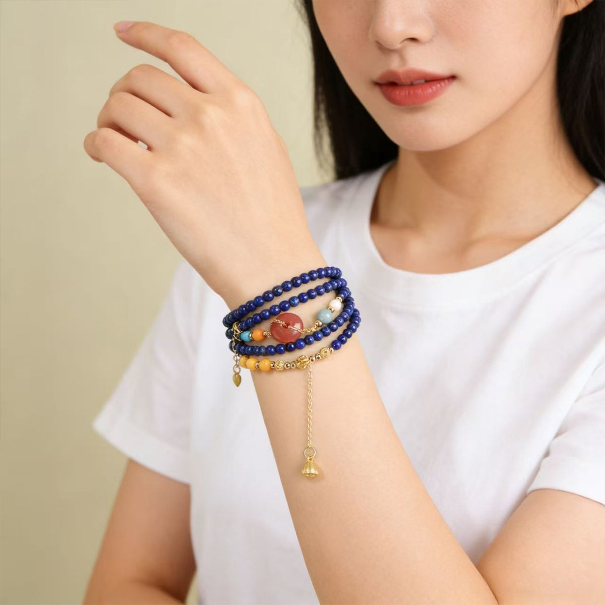 Lapis lazuli and amber wrap bracelet worn on a wrist